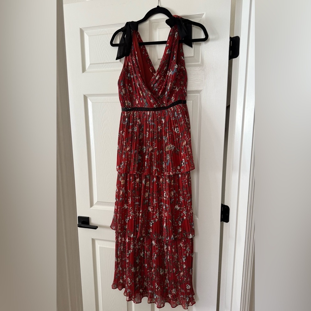 Long red floral formal dress with black bow ties at top